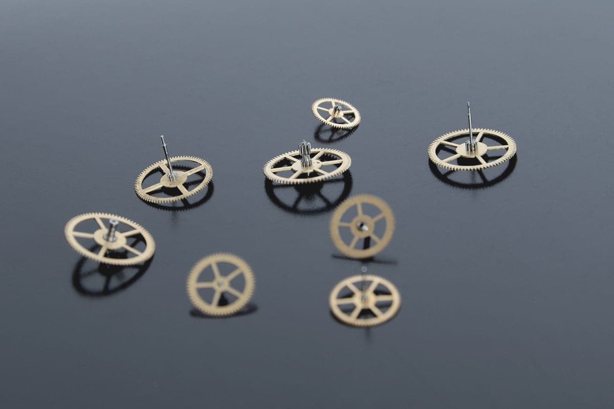 Small metal jewelry findings arranged on a white surface