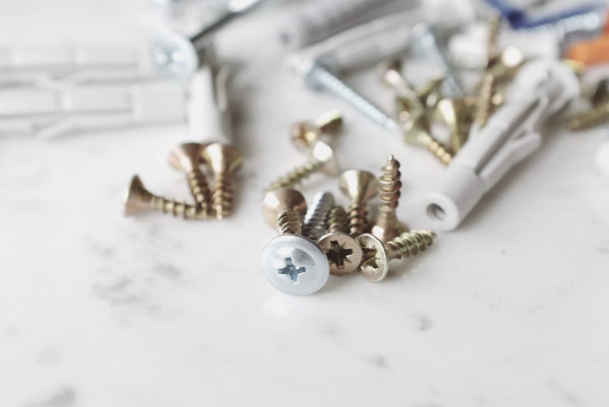 Small metal jewelry pieces arranged on a pale surface