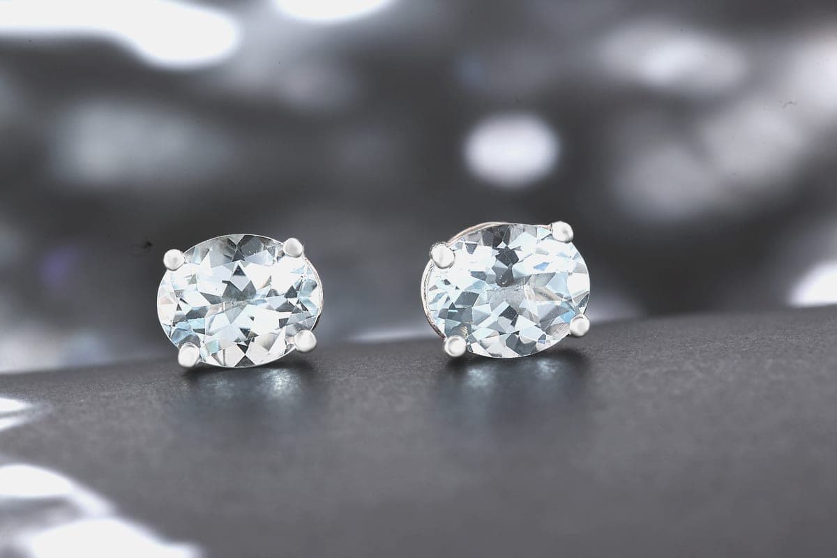 A pair of clear gemstone stud earrings photographed close up