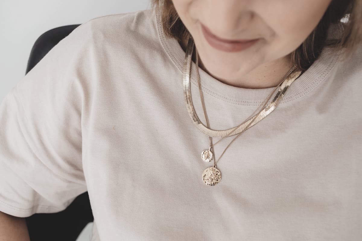 Fine layered gold necklaces photographed close to the neck
