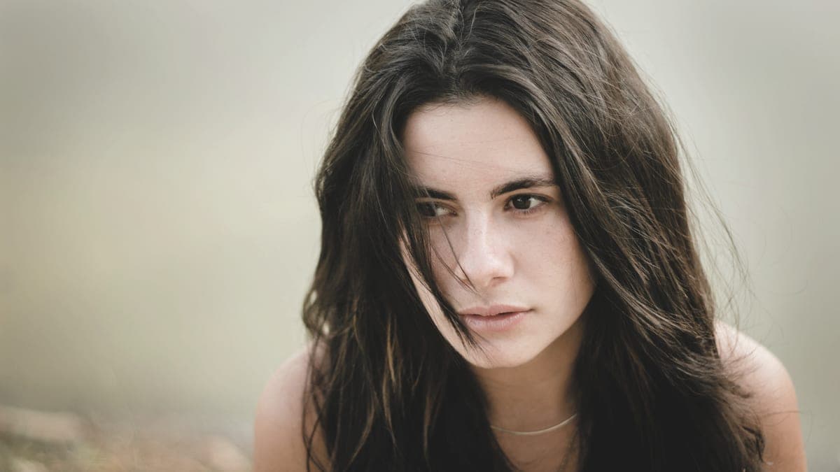Portrait of a person against a neutral background in soft light