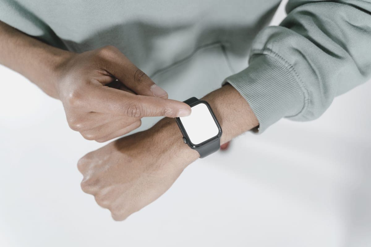 A smartwatch worn on a wrist against a neutral background